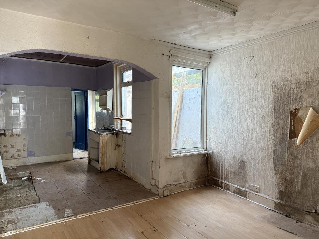Lot: 83 - TWO-BEDROOM SEMI-DETACHED HOUSE FOR IMPROVEMENT - Dining room with kitchen area